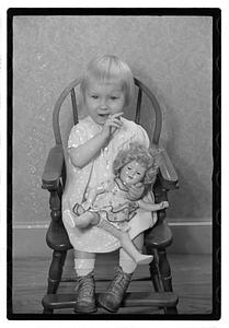 A girl holding a doll
