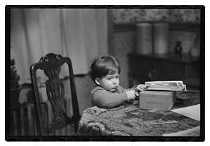 Toddler sitting a table