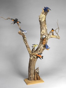 View of minature birds on driftwood