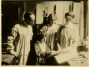 Teacher with students looking at a drawing