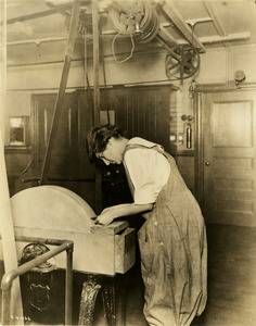 Female student using woodshop tool