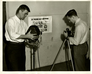 Students photographing posters for civil defense
