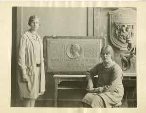 Two students with plaque memoralizing Charles Frederick Whitney