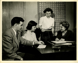 People in conversation at desk