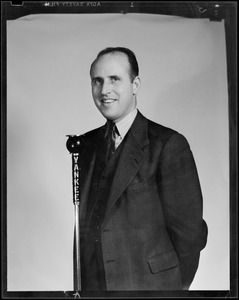 Unidentified man, possibly Dana Fitzgerald, posing at Yankee Network microphone