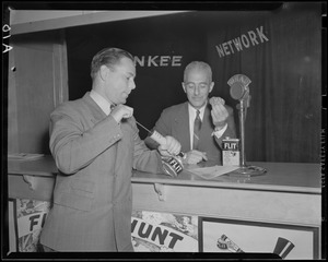 Two unidentified men posing with Flit insecticide at WNAC Yankee Network booth