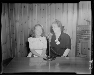 Unidentified woman and girl sitting at WNAC microphone