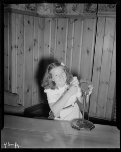 Unidentified girl sitting at WNAC microphone