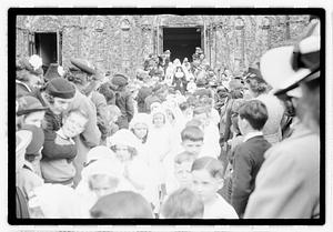 A group of children coming out of a church after their first Communion