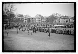 Crowd surrounding a football field