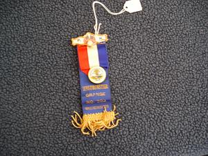 Blue ribbon with gold lettering and fringe