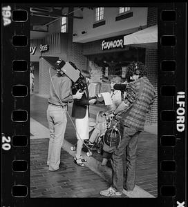 Market researcher interviews customers at shopping mall in Brighton