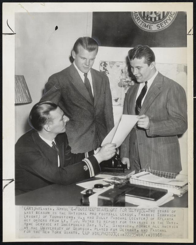 Football Stars off for Service- Two stars of last season in the National Pro Football league, Frankie Sinkwich (right) of Youngstown, O., and Billy Paschal (center) of Atlanta get orders from Lt. F.J. Mitko to report for training in the Maritime Service at Sheepshead Bay, N.Y. Sinkwich, former All America at the University of Georgia, played for Detroit, and Paschal for the New York Giants.