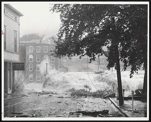 “The Terrible Torrent” by John P. Callahan of the Providence Journal-Bulletin shows the Putnam, Connecticut, flood. It won a tie for third prize in the Spot News category in the 13th annual “News Pictures of the Year” competition, jointly sponsored by the National Press Photographers Association and Encyclopaedia Britannica.