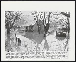 Southeast Tennessee Flood-Flood waters surround this Jasper residential area today in wake of tornadoes which struck nearby Monday night. State troopers said a family of four drowned in this area after their farm home was destroyed by rampaging waters. Flooding was widespread today in East Tennessee.