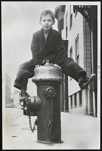 Five-Year-Old Russel Quigg of South Boston shows that spring is something to jump with joy about as he vaults hydrant near his H St. home.