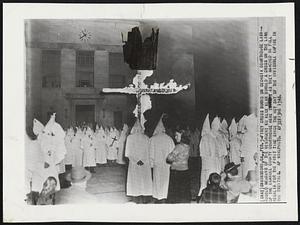 Firey Cross Burns on Georgia Courthouse Lawn--Hooded members of the resurgent Ku Klux Klan burned a cross on the lawn of the Emanuel County Courthouse here as they marched in full regalia for the first time since the hey day of the invisible empire in the twenties.