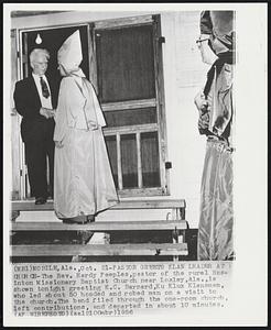 Pastor Greets Klan Leader at Church-The Rev. Hardy Peeples, pastor of the rural Rosinton Missionary Baptist Church near Loxley, Ala., is shown tonight greeting E.C. Barnard, Ku Klux Klansman, who led about 50 hooded and robed men on a visit to the church. The band filed through the one-room church. left contributions, and departed in about 10 minutes.
