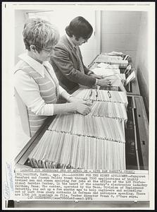 Looking for the Right Applicant--Margaret Hansford and Joseph Delito thumb through 3500 applications of highly trained men and women applying for jobs at the office of the 128 Professional Service Center, in the heart of the country’s electronics industry Waltham, Mass. The center, operated by the Mass. Division of Employment Security, was set up a few months ago to help engineers and scientists out of work from sharp cutbacks in defense and aerospace spending. There are 1300 job openings on file, Center director Frank G. O’Hare says.