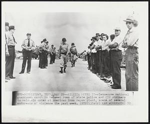 Morristown, Tenn. – Militia Moves In – Tennessee national guardsmen march in between rows of state police and CIO strikers to maintain order at American Enka rayon plant, scene of several outbreaks of violence the past week.