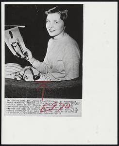 Million-Dollar Sweetheart-- Nancy McNamara, student at St. Mary's College here, proudly holds a photo of her fiance, pitcher Herb Score of the Cleveland Indians, for whom the Boston Red Sox reportedly offered one million dollars. Miss McNamara and Score, high school sweethearts at Lake Worth, Fla., plan to be married in October.