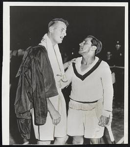 "Cheer Up, Pal"-Pancho Segura (right) of Ecuador, who won the professional tennis crown last night at Cleveland, consoles Frank Kovacs of Oakland, Calif. Leg cramps forced Kovacs to quit in the fourth set with Segura leading 2-1 in sets.