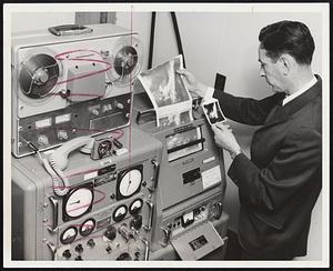 Automatic picture transmission equipment for receiving the NIMBUS satellite transmissions is examined by Thomas J. Keegan, chief of the Air Force Cambridge Laboratory's Satellite Meteorology Unit.
