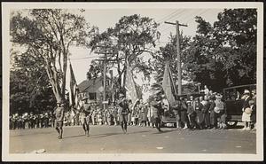 Soldiers marching in a parade on Main Street in Sharon, holding flags