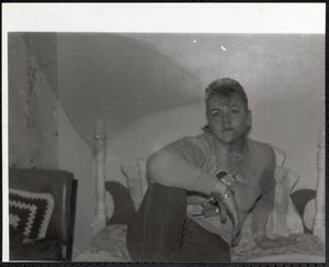 Young woman sitting on a bed