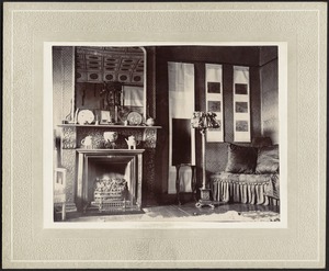 First house in China —Interior — View of room with fireplace and wall hangings, mirror reflects decoratively painted ceiling