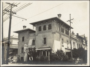View of 3-story building, man standing in foreground