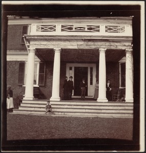 Joseph Randolph Coolidge standing with others (possibly Virginia relatives) on front porch of Georgian-style brick house