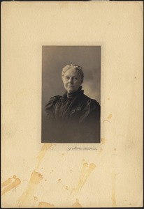 Jane Armington Brown in black dress, pince-nez hanging
