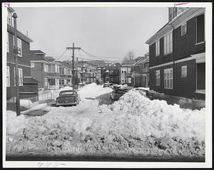 Unplowed streets and parked cars present threat to residents in event of fire. Hundreds of side streets in suburbs, like Woodfield, St., Dorchester, are unplowed.