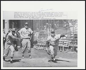 Two of Cardinals Best--Joe Becker, center, new pitching coach of the St. Louis Cardinals, watches star pitchers of the Cardinals, Bob Gibson, left, and Curt Simmons take their first workout at spring training camp in St. Petersburg yesterday. Gibson won 19 games in 1964, Simmons 18.