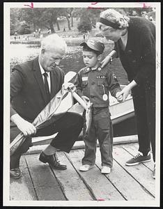 Little John Curtis, 4. of West Roxbury, is given first prize of fishing tackle in Fishing Rodeo and Pet Show. Mother, Mrs. John Curtis, looks on, as Pat Ryan of Park Department makes award.