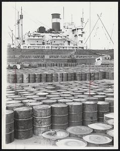 Tied up by Strike--Drums of asphalt, destined for shipment abroad wait on Castle Island piers.