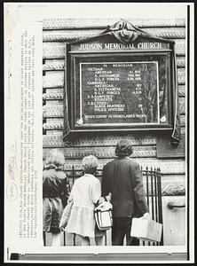 In Memoriam -- Passersby view the bulletin, draped in black mourning cloth, of New York's Judson Memorial Church which lists the "body count" of the persons killed in what the Baptist church terms as "undeclared wars." Included in the list are students killed on U.S. campuses, slain Black Panthers and police officers. "N.L.F. Forces" listed are Viet Cong dead.