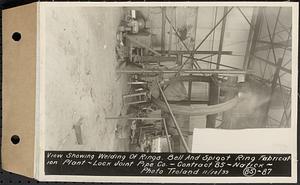 Contract No. 85, Manufacture and Delivery of Precast Concrete Steel Cylinder Pipe, Southborough, Framingham, Wayland, Natick, Weston, view showing welding of rings, bell and spigot ring fabrication plant, Natick, Mass., Nov. 10, 1939