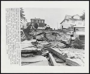 Sliding Earth Destroys Homes--Softened by incessant rains this hilly section of the city continued to slide today, damaging or destroying some 30 homes. Many will not be salvageable. The earth has been settling for several days and has dropped an additional 12 to 15 feet in the past 12 hours. Continuing rainfall is expected to cause further havoc.`