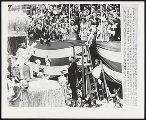 Rex Toasts His Queen--Rex, King of Carnival and Lord of Misrule toasts his queen, Miss Mary Brooks Soule, holding bouquet at the reviewing stand in front of the Boston Club here today. With the queen are members of the royal party.