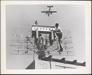 Radio Engineers C. R. Lundquist and K. S. Kellaher install radio antenna