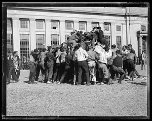 A crowd of people climbing atop each other, MIT