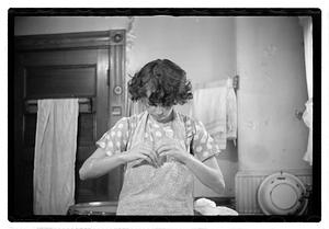 A woman looking down at her hands