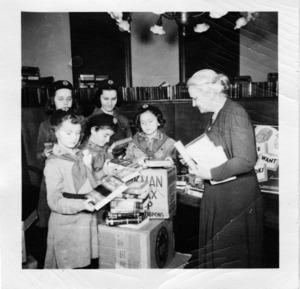 Librarian Lydia Masters and five Girl Scouts packing boxes for the "Books for Servicemen" program during World War II. Watertown Free Public Library, 1943.