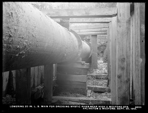 Distribution Department, Low Service Pipe Lines, lowering 20-inch main for dredging Mystic River near High and Medford Streets, Arlington; Medford, Mass., Sep. 30, 1910