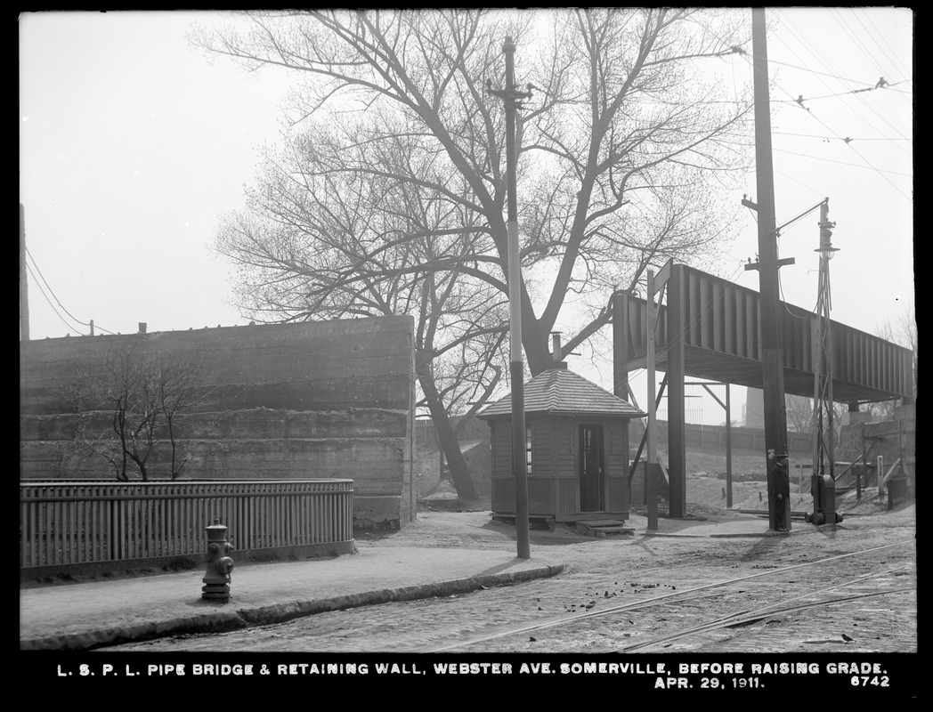 Distribution Department, Low Service Pipe Lines, pipe bridge and retaining wall, Webster Avenue, before raising grade, Somerville, Mass., Apr. 29, 1911