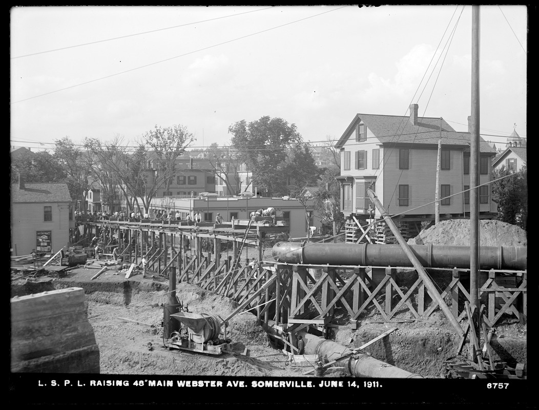 Distribution Department, Low Service Pipe Lines, raising 48-inch main Webster Avenue; house on crib-work in middle ground, right, Somerville, Mass., Jun. 14, 1911