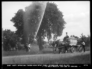 Distribution Department, Low Service Spot Pond Reservoir, spraying trees near Spot Pond, 1/4-inch nozzle, 225 lbs. at engine; "Metropolitan Water Works" on tank sides, Stoneham, Mass., Jul. 18, 1911