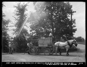 Distribution Department, Low Service Spot Pond Reservoir, spraying trees corner of South and Main Streets, with 1/8-inch nozzle, 250 lbs. at engine; "Metropolitan Water Works" on tank sides, Stoneham, Mass., Jul. 18, 1911